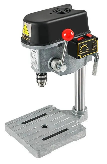 Bench drill milling machine on a workbench with cross bench pliers.
