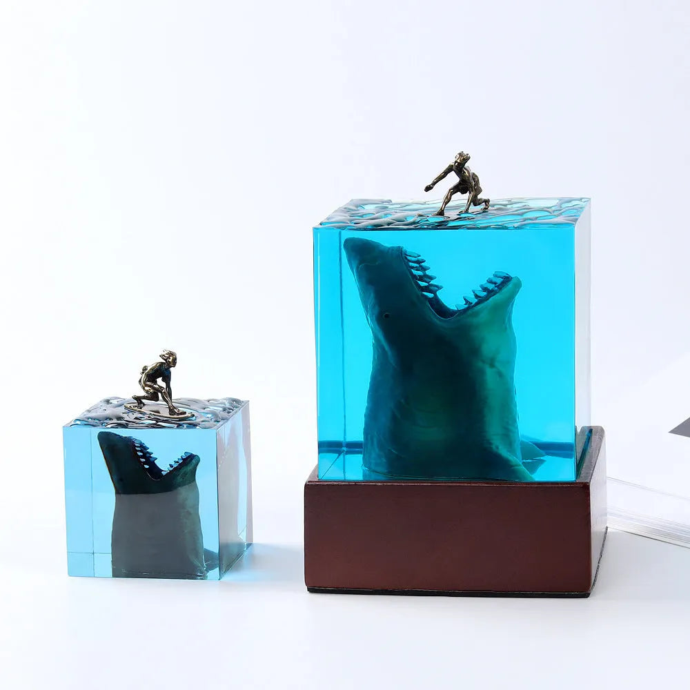 Clear epoxy resin ornament with a detailed shark surfing scene inside, shown next to its integrated lamp holder.