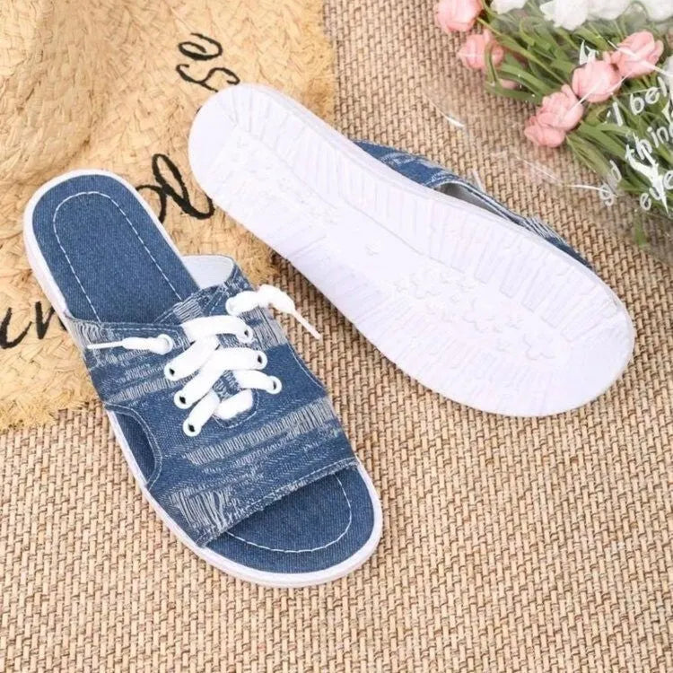 Blue women's flat canvas roman slippers with cloth lining and a rubber sole.