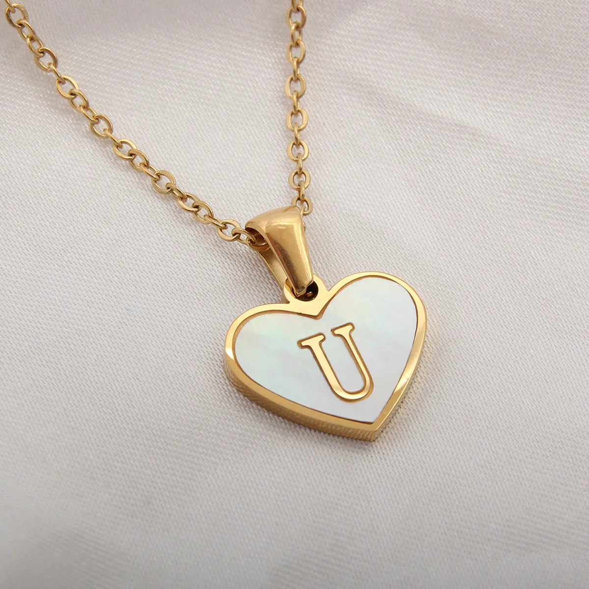 Gold heart necklace with white shell pendant and initial charm on 45cm adjustable chain