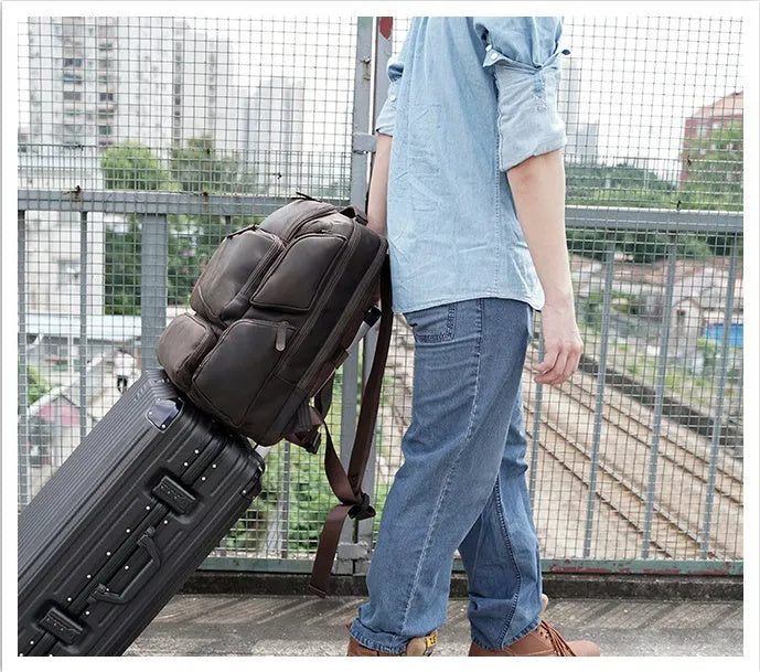 Dark brown leather backpack with 17-inch laptop compartment and multiple internal pockets