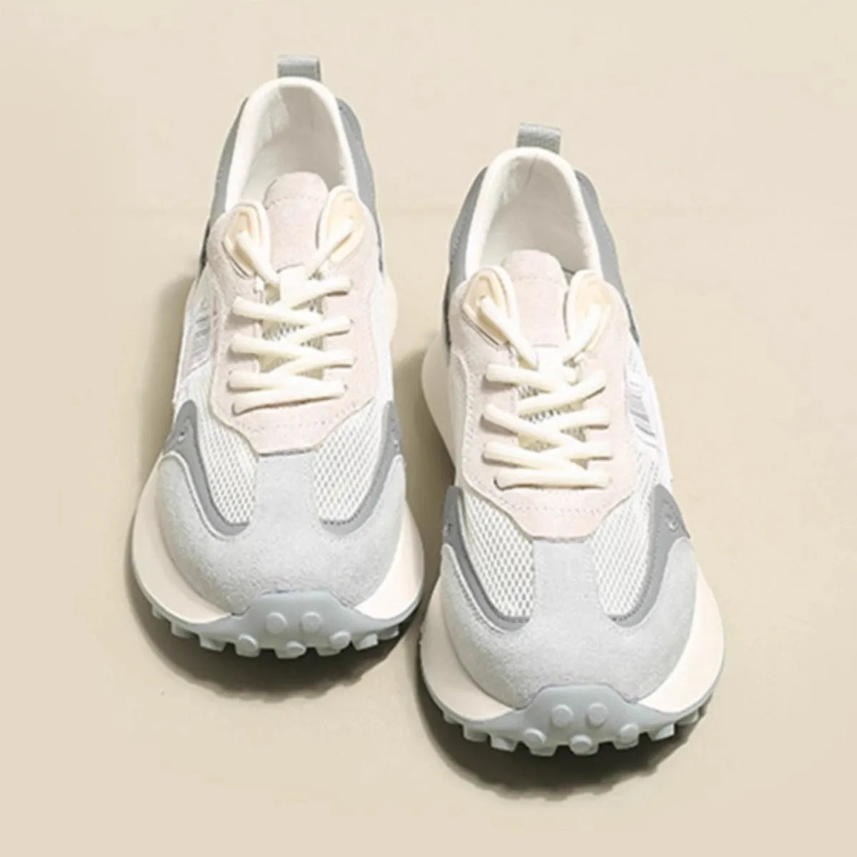 Women's gray and pink retro sneakers with mesh lining, rubber sole, and low-top design