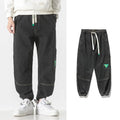 Men's cotton loose-fit tapered trousers in black, blue, and grey colours