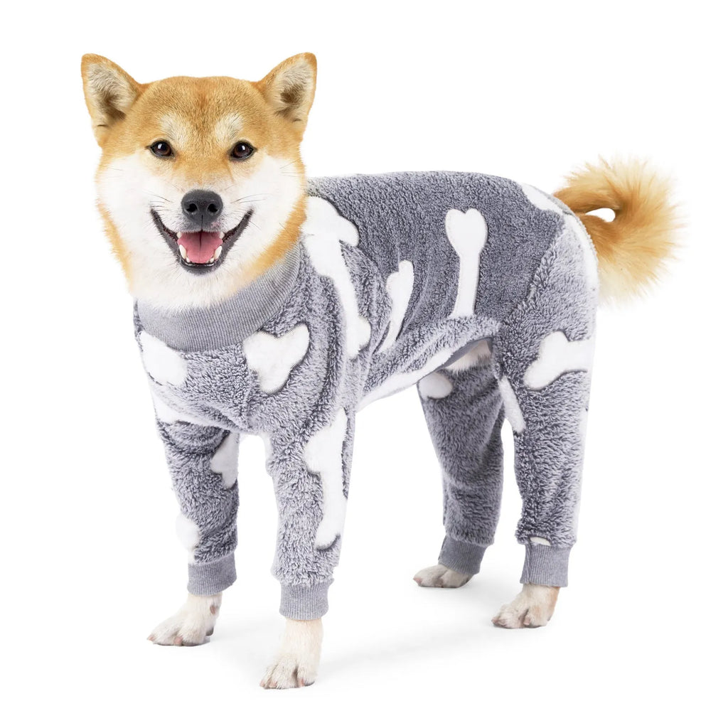 Winter dog pajamas in flannel, bone grey colour, size M, on a small dog standing indoors