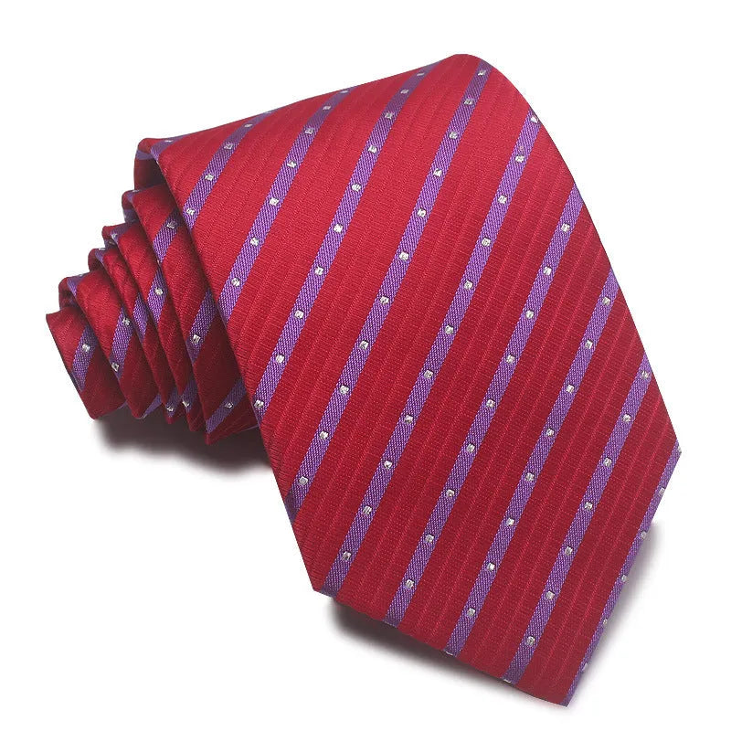 Close-up of a man's striped jacquard woven tie in a classic arrow shape, showing textured fabric detail.