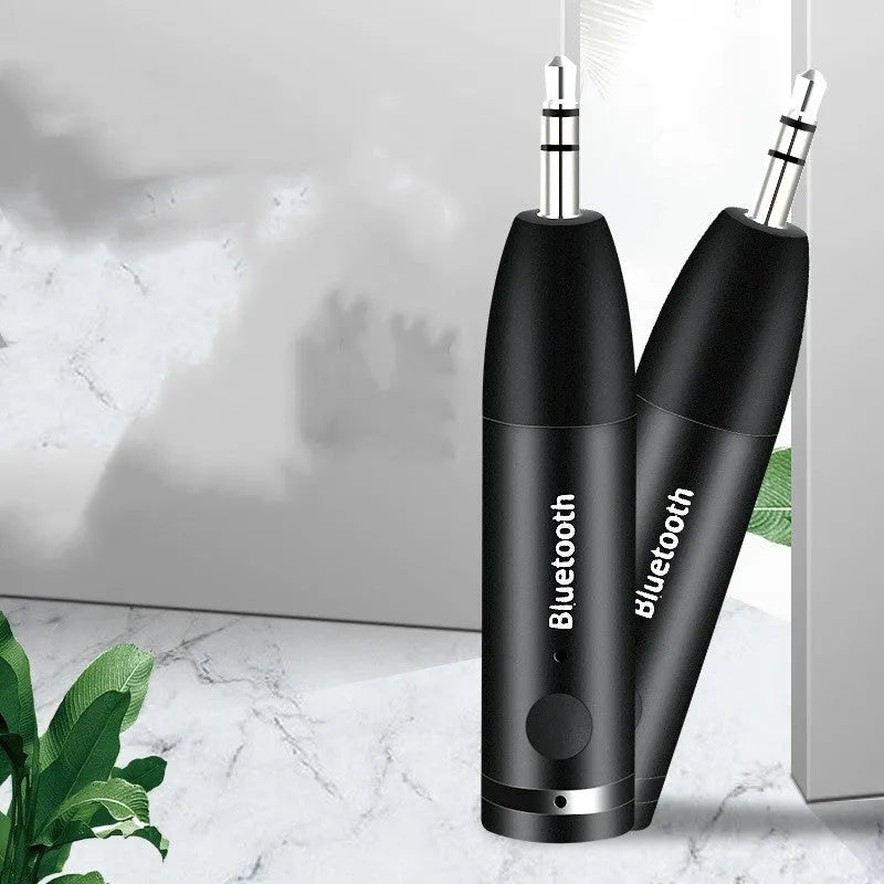 Black car Bluetooth audio receiver with USB cable for wireless music streaming to AUX stereo systems