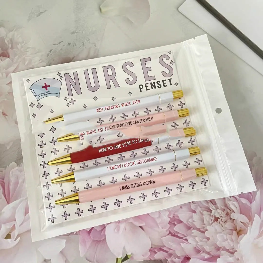 Set of five plastic retractable ballpoint pens with nurse-themed text and slogans.