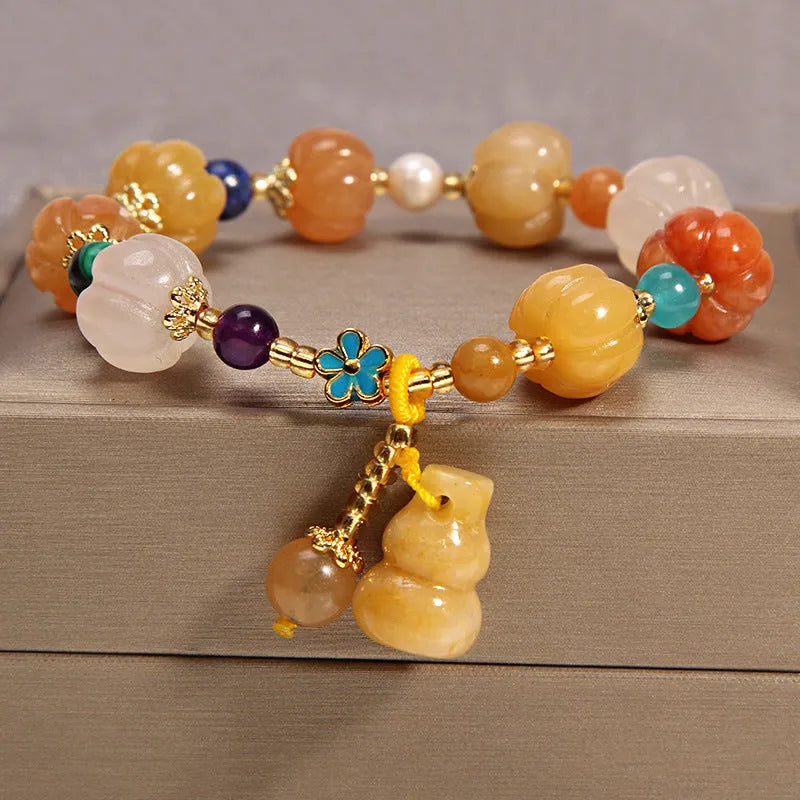 Khaki crystal bead bracelet on an adjustable gold silk cord.