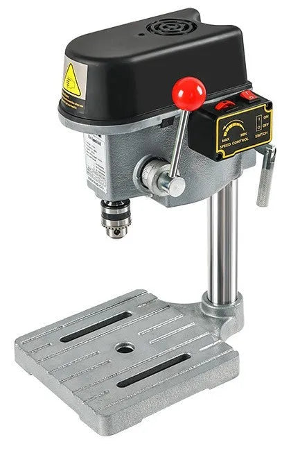 Bench drill milling machine on a workbench with cross bench pliers.