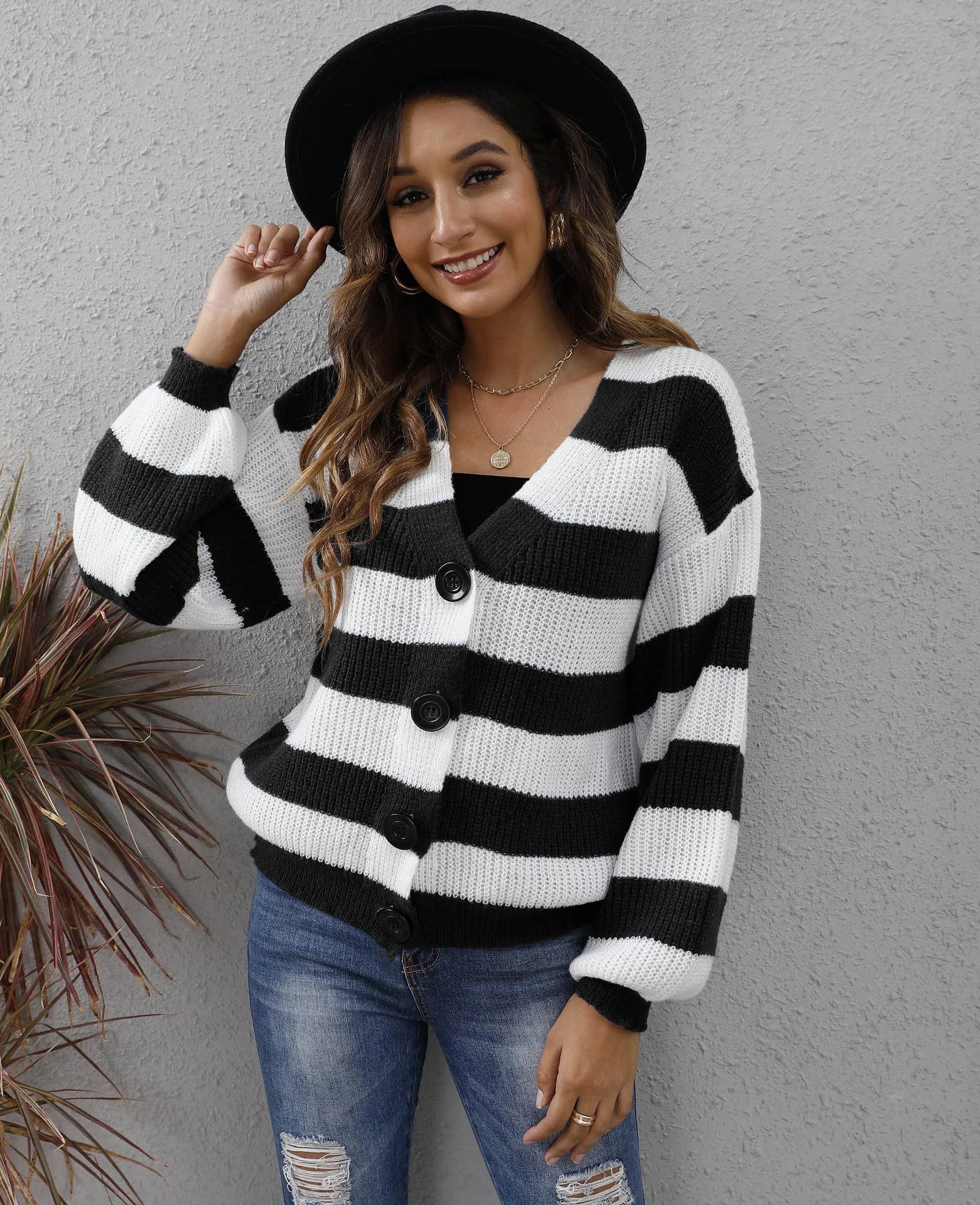 Women's striped cardigan sweater in deer plush polyester fabric on a hanger.
