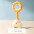 Blue cloud shape jaw dog pooper scooper on a lawn