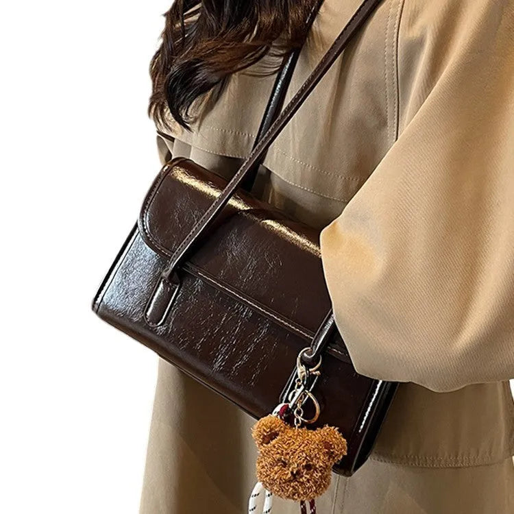 Women's brown PU leather shoulder bag with horizontal square shape and decorative pendant