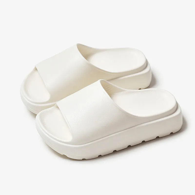 Women's beige fish mouth slippers with a thick 5.5cm EVA platform sole on a wooden floor.