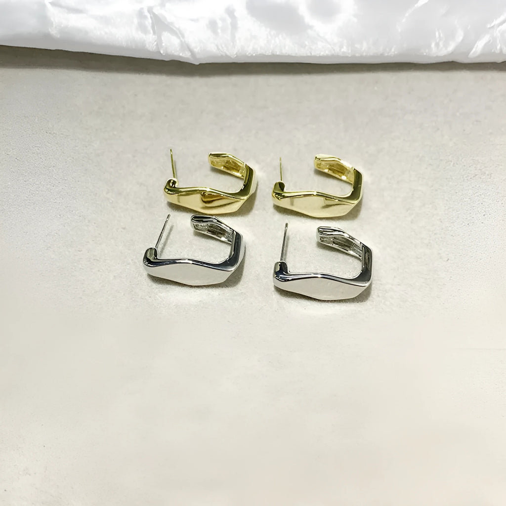 Irregular C-shaped metal stud earrings in Gold finish, minimalist design for everyday wear.
