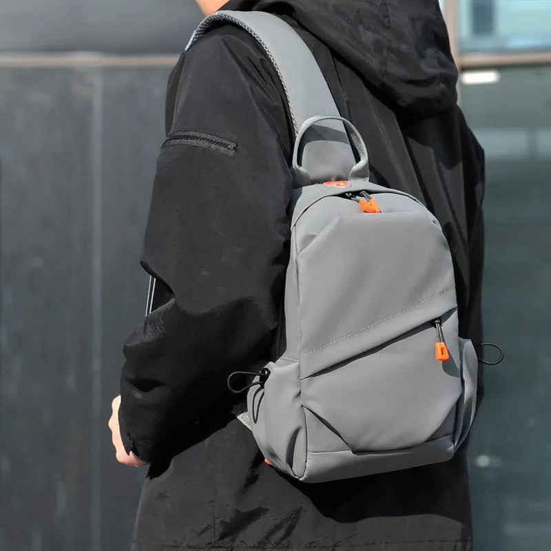 Men's black polyester crossbody bag with single shoulder strap shown in casual setting