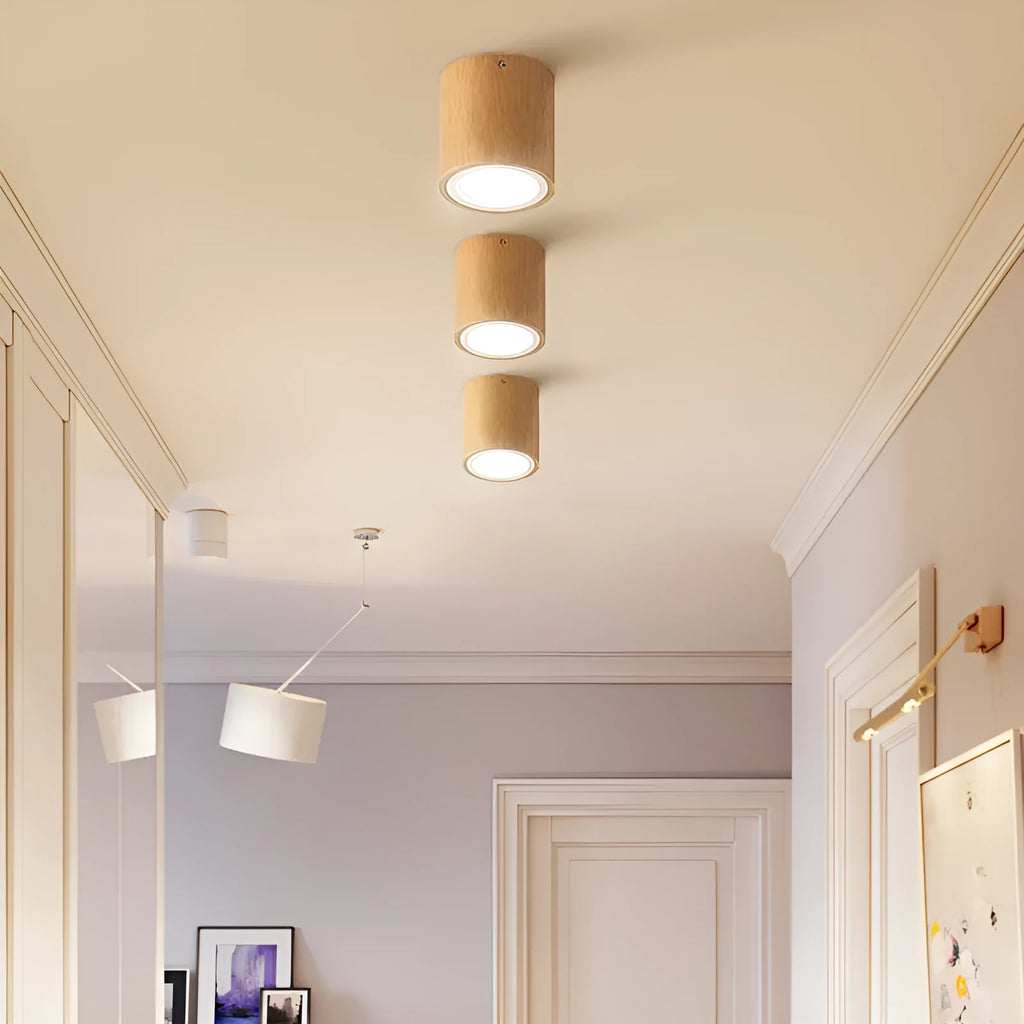 Modern solid wood surface mounted downlight in wood colour, shown in round and square designs for corridor or entrance ceilings.