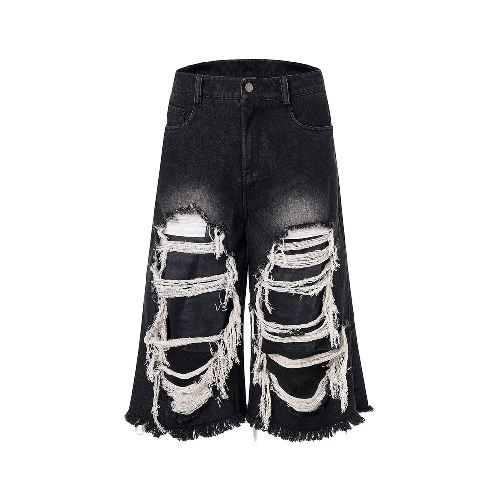 Black cropped wide leg jeans with mid-high waist and ripped patch detail on a loose fit.