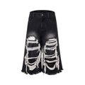 Black cropped wide leg jeans with mid-high waist and ripped patch detail on a loose fit.