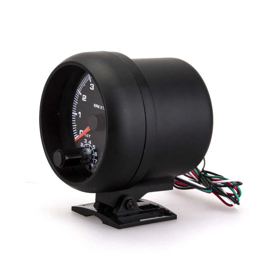 Black plastic automotive tachometer with blue-lit dial showing 0-8000 RPM scale.