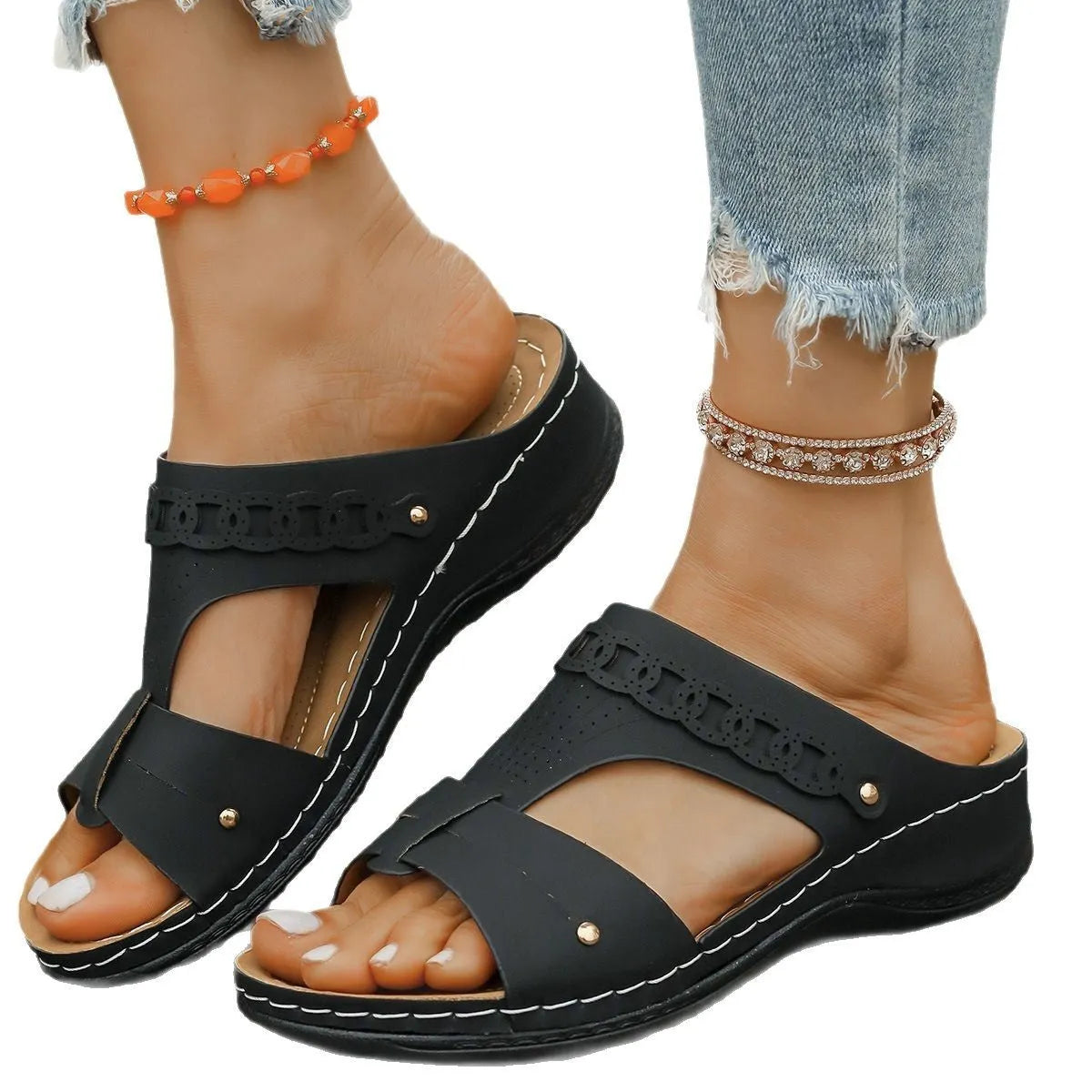 Slope heel roman style slippers with fish mouth toe holder in various colours on a rubber sole.