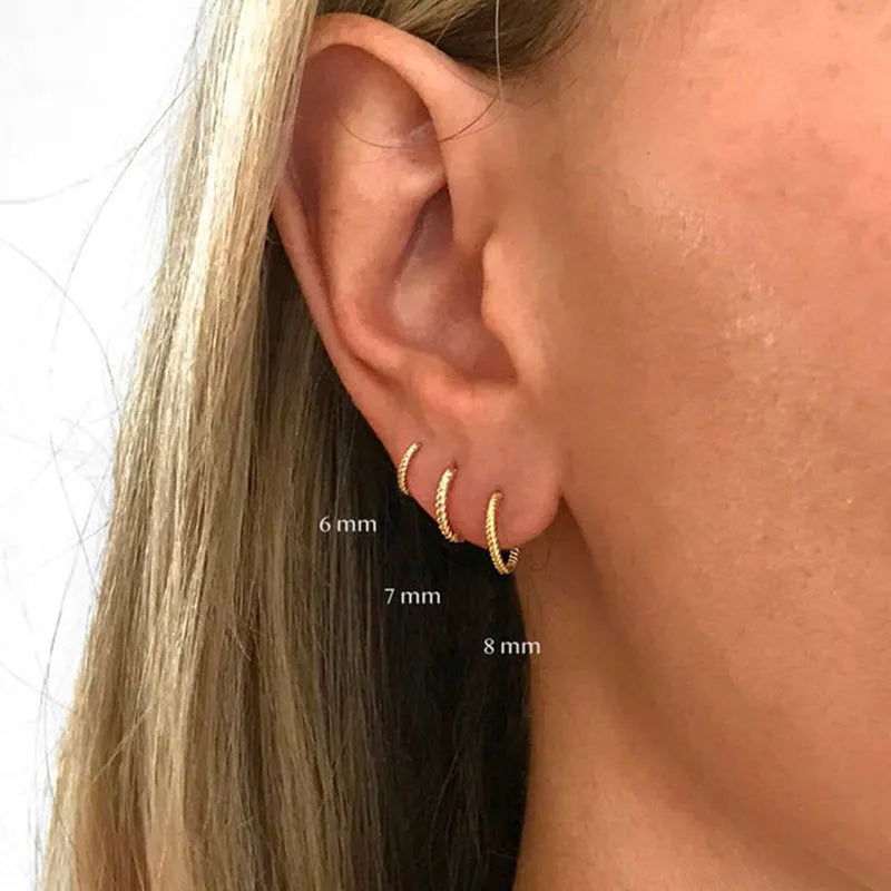 Close-up of S925 sterling silver twisted string round hoop earrings in gold finish.