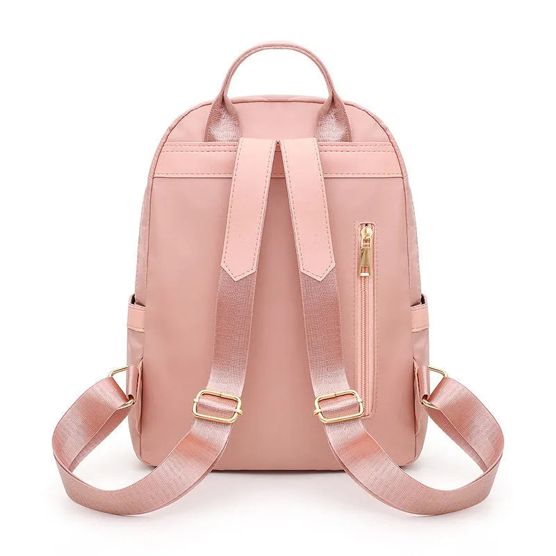 Women's black nylon backpack with square vertical shape showing internal compartments and shoulder straps