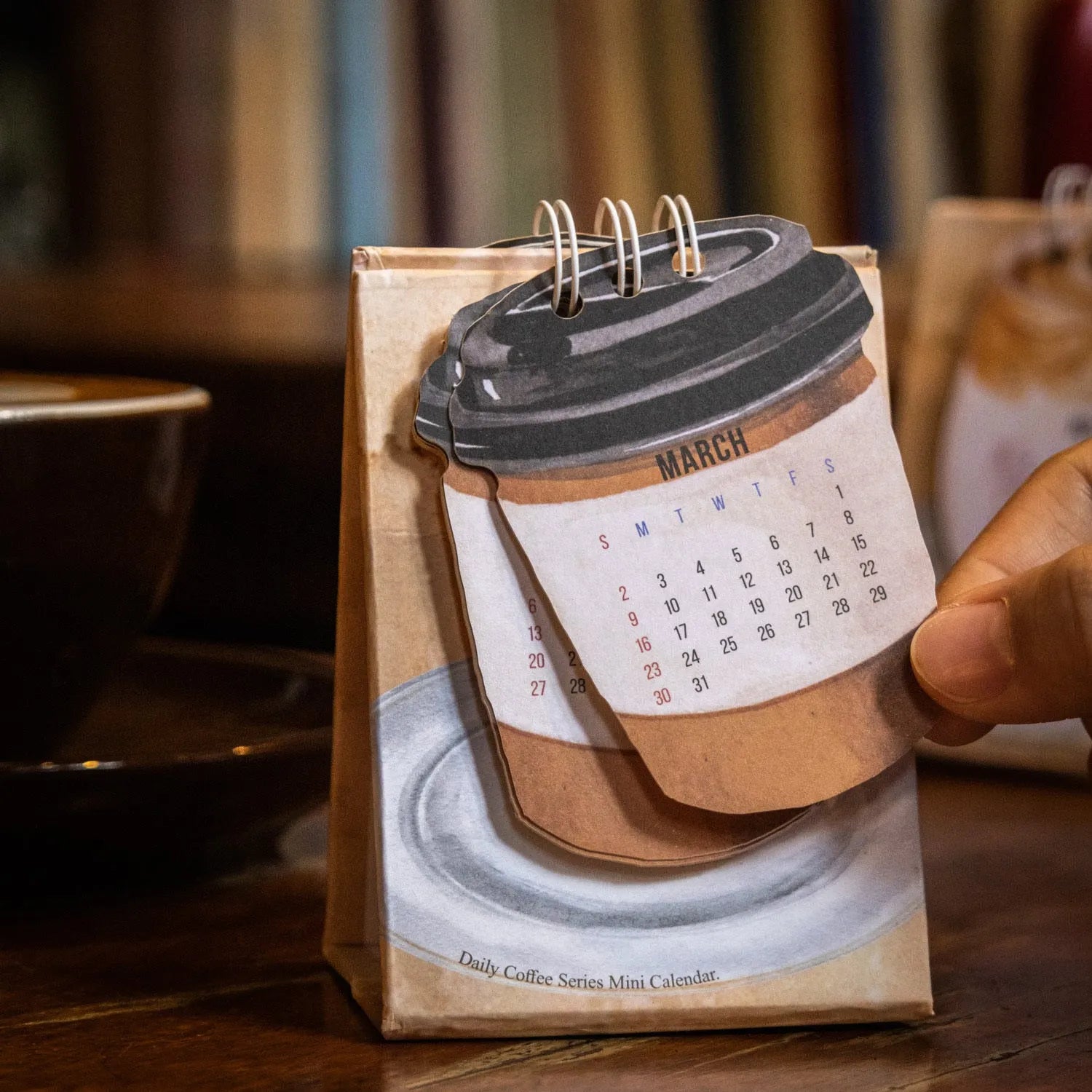 Coffee-themed 2025 mini desk calendar showing four simple modern design options