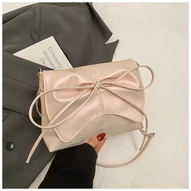 Women's black PU leather crossbody bag with a horizontal square shape and crossbody strap