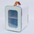 Pink mini refrigerator with transparent door showing interior storage for cosmetics