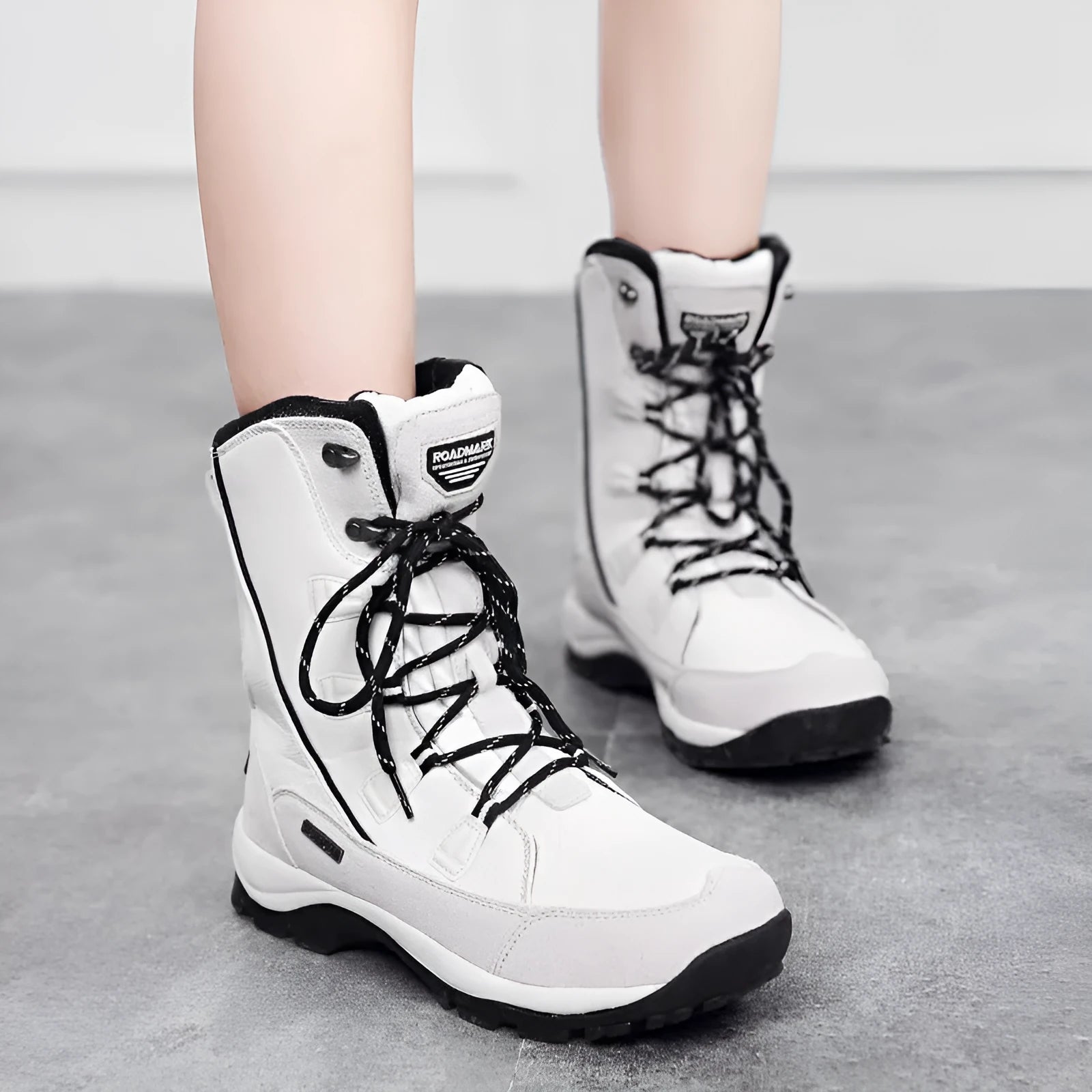 Women's black genuine leather mid-calf snow boots with a round toe and rubber sole on a white background.