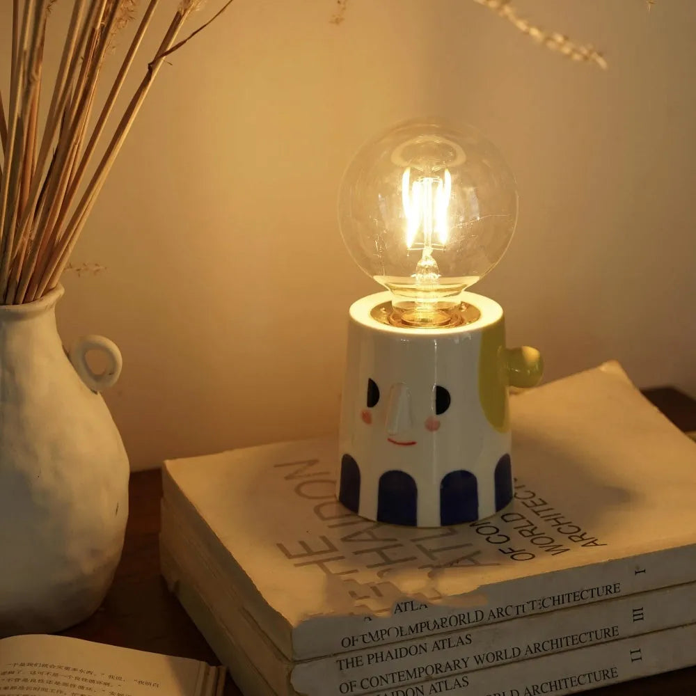 Handmade ceramic bedside lamp with ball headlight colour on wooden table