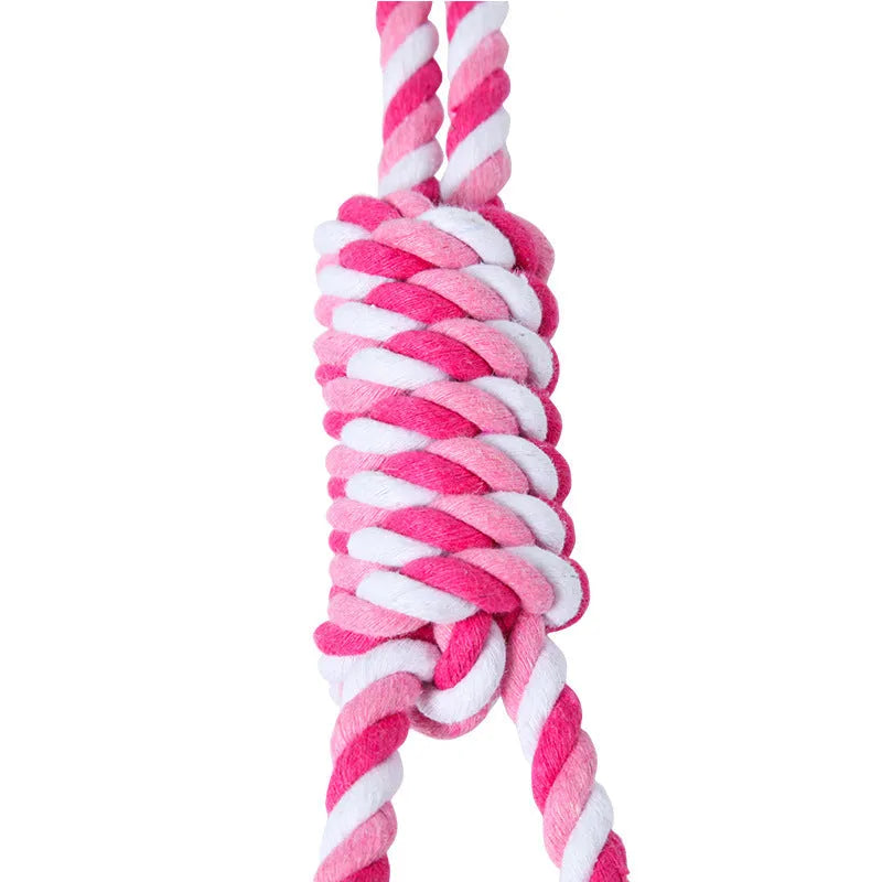 Red and white cotton rope tug toy for dogs, approximately 38cm long, laid out straight.