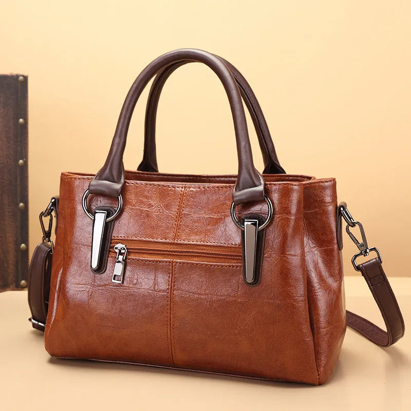 Horizontal square PU leather shoulder bag with contrasting sewing thread detail and organised interior compartments