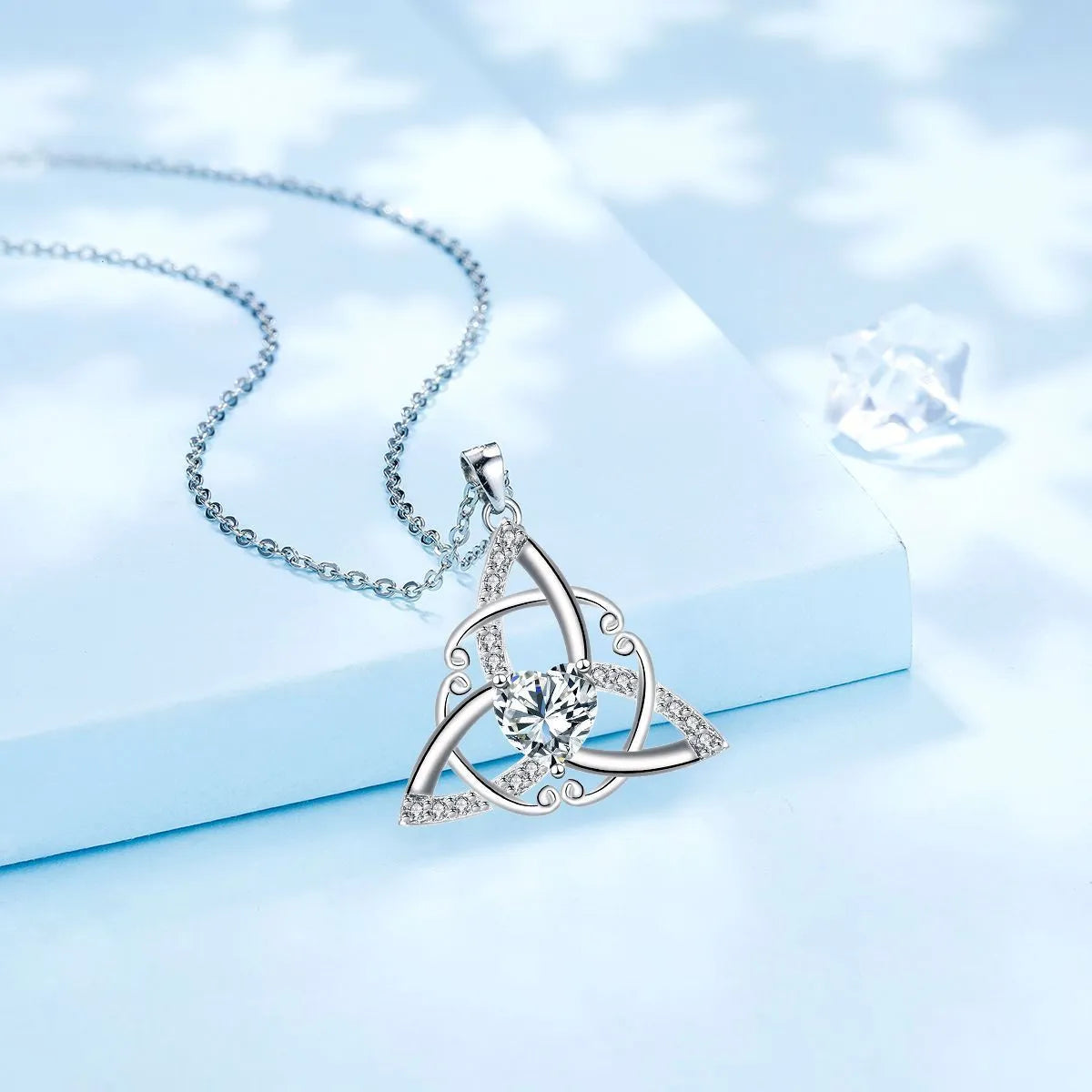 Women's geometric Celtic knot pendant necklace in electroplated copper, showing blue colour option.