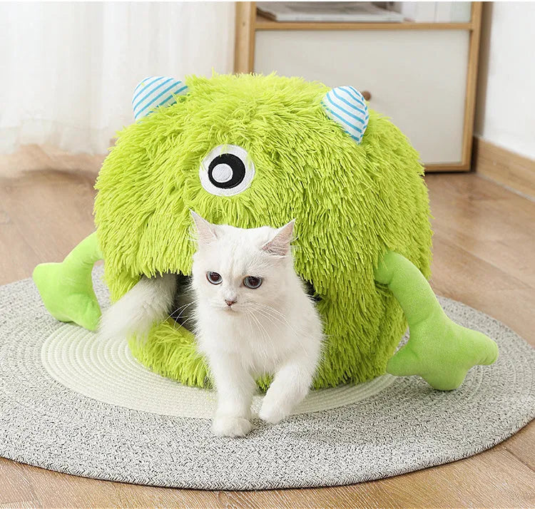 Fluffy round plush cat bed with a non-slip base, shown in a home setting.