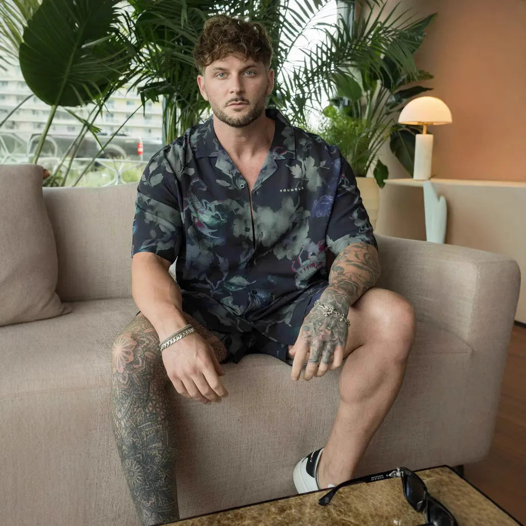 Man wearing a loose, short-sleeve printed cardigan top in a floral pattern.