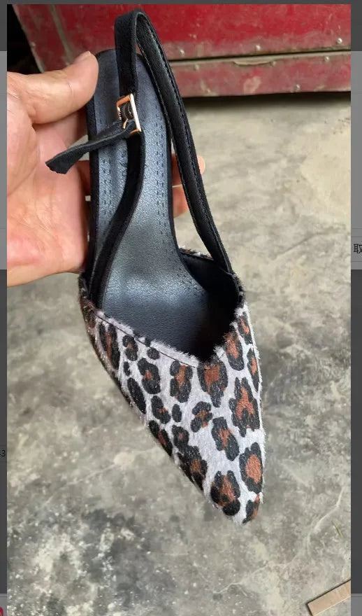 Women's leopard print suede high heel sandals with a pointed toe on a white background.