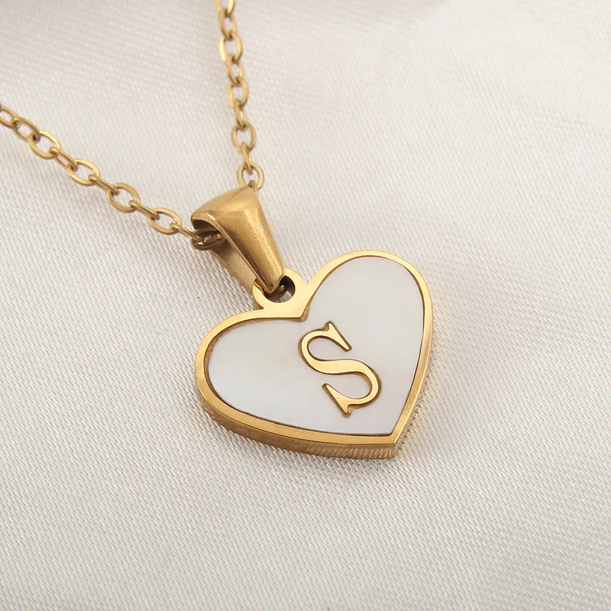 Gold heart necklace with white shell pendant and initial charm on 45cm adjustable chain
