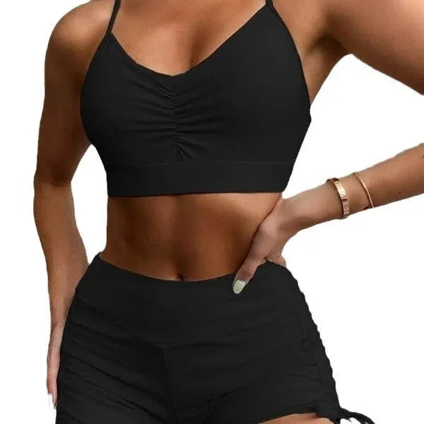 Women's black high waist split bikini swimsuit top and shorts laid flat.