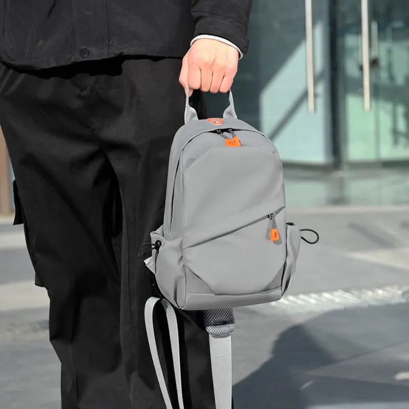 Men's black polyester crossbody bag with single shoulder strap shown in casual setting