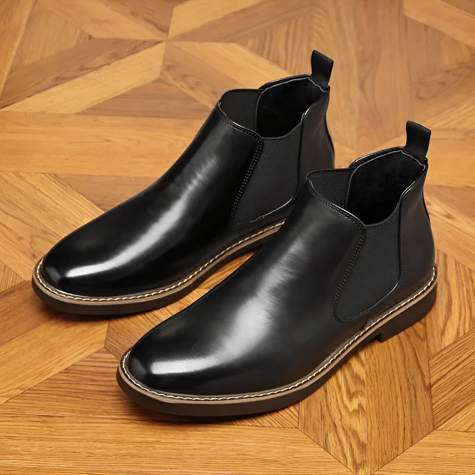 Black formal pointed-toe leather boots with a square heel and rubber sole on a neutral background.