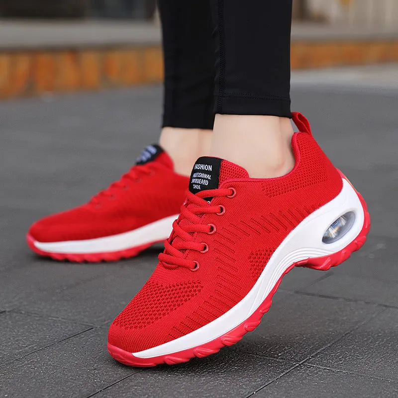 Red women's mesh sneakers with front lace-up and round toe design