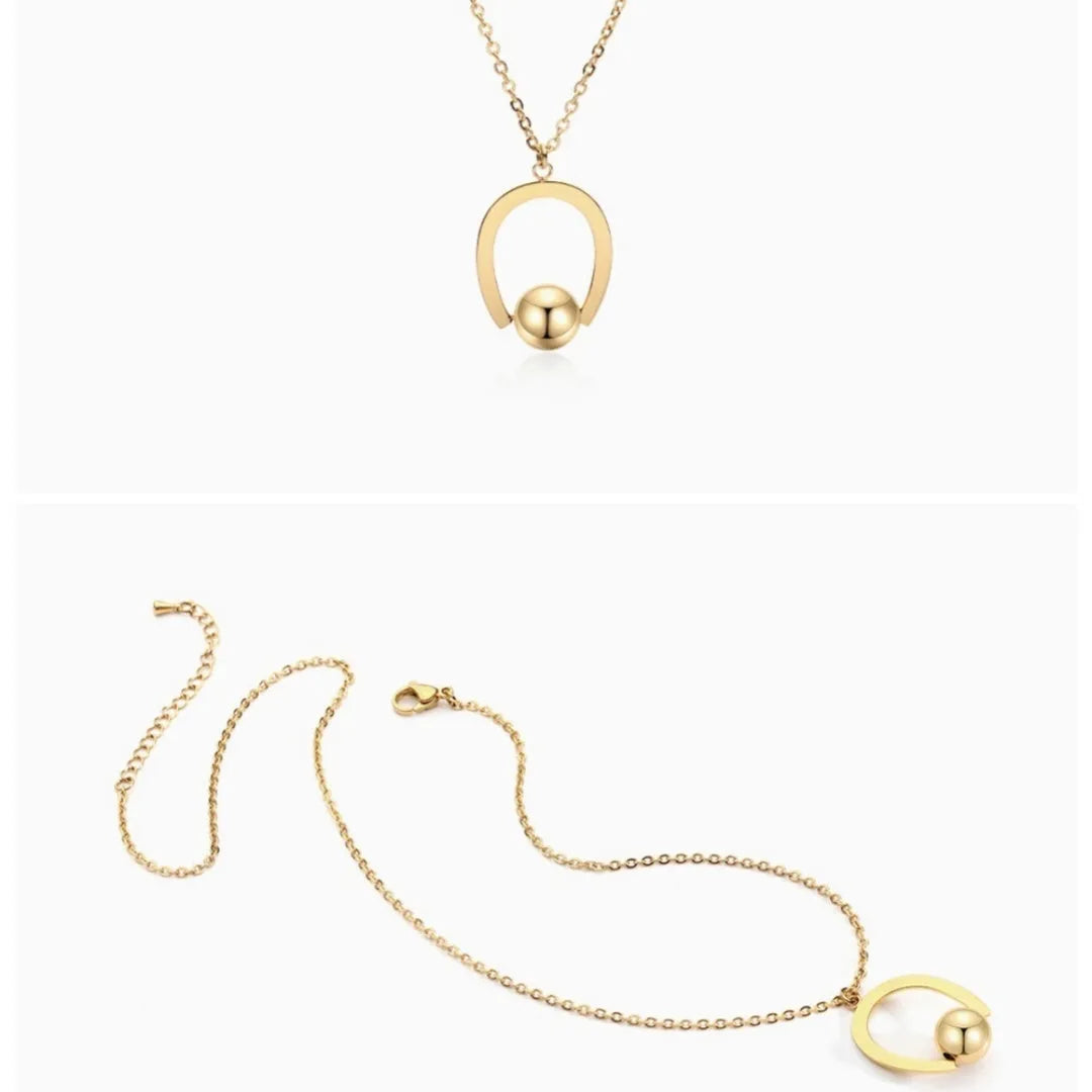 Gold or silver electroplated stainless steel geometric pendant necklace on a cross chain.
