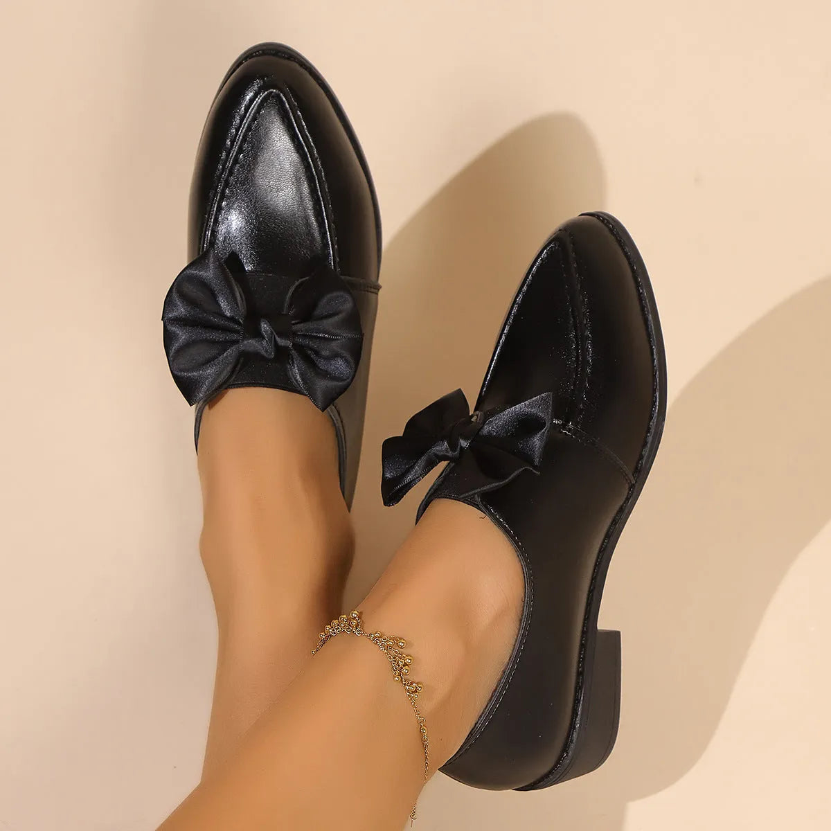 Women's British-style leather shoes with bow detail showing PU upper and rubber sole construction