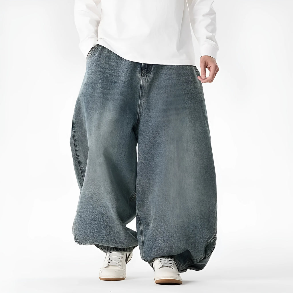 Men's loose-fit straight leg jeans in black denim on a hanger.