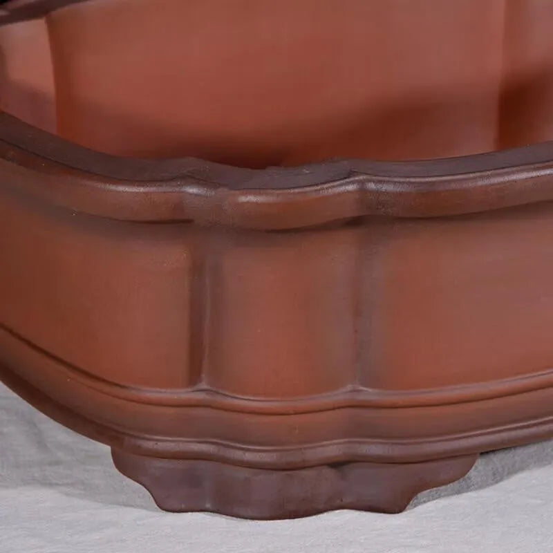 Large antique-finish Chinese purple clay flower pot with detailed tree stump and floral motif sculpture.