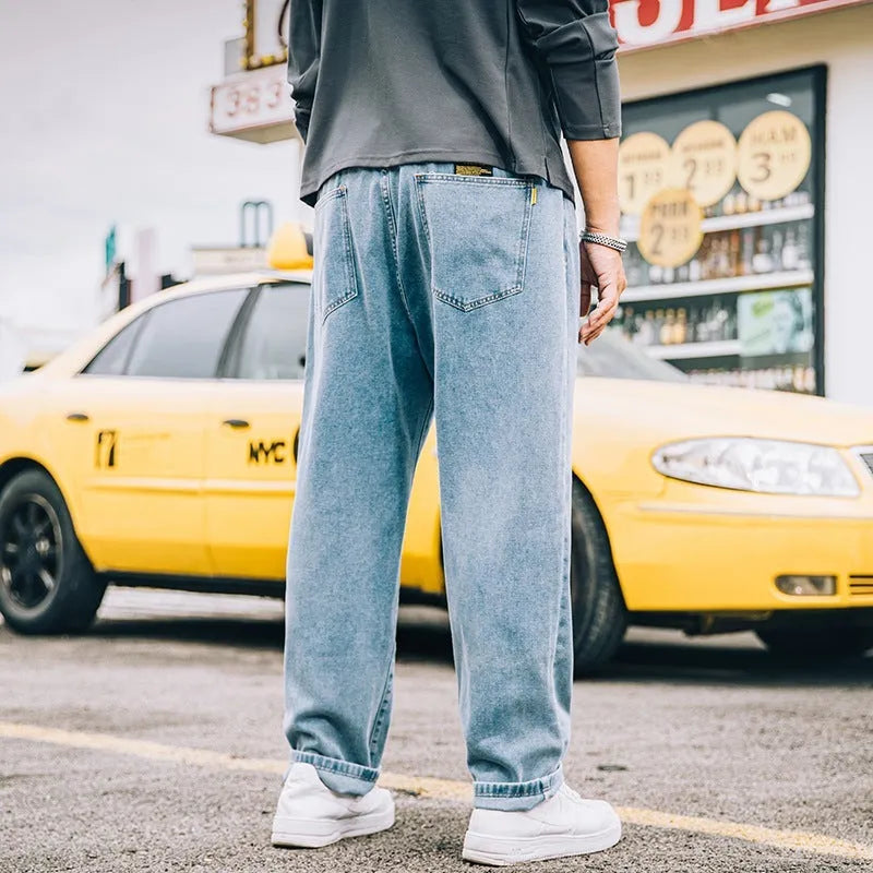 Men's loose straight jeans in cotton fabric showing mid waist fit and straight leg cut