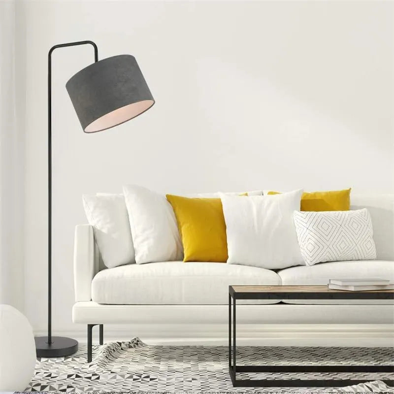 Black LED floor lamp with fabric shade and adjustable head in living room setting