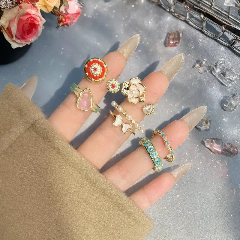 Adjustable copper women's ring with vintage oil drip finish, gourd shape, and inlaid zircon stones in floral and bow designs.
