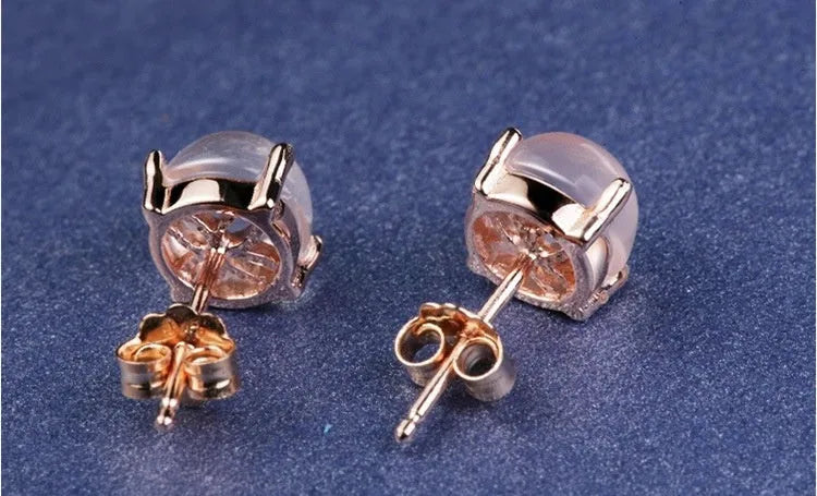 Rose gold drop-shaped stud earrings with crystal inlay detail.